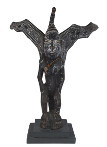 Winged spirit figure, carved wood, shell, fibre and earth pigments, Papua New Guinea, mid 20th century, mounted on later wooden plinth, 94cm high, 104cm high overall