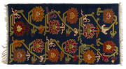 A Chinese hand-woven rug with floral motif on blue background, circa 1920, 172 x 95cm