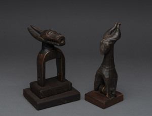 Two African weaving pulleys in the form of horned beasts, carved wood, Baule tribe, Ivory Coast, on later wooden plinths, 18cm and 19cm high overall