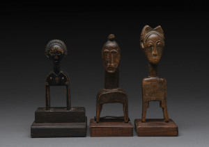 Three African weaving pulleys, carved wood, Baule tribe, Ivory Coast, on later wooden plinths, 17cm, 18cm and 20cm high overall