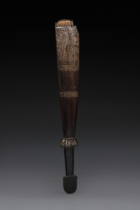 A sword club, carved wood, piped clay and fibre, Milne Bay area, Papua New Guinea, 62cm long