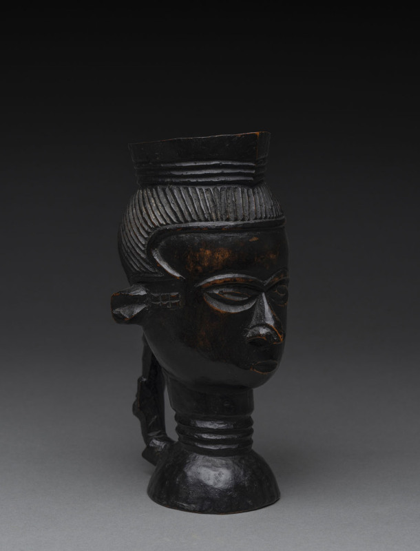 An African ceremonial face cup with figural handle, carved wood, Bakuba tribe, Central Congo, 19.5cm high