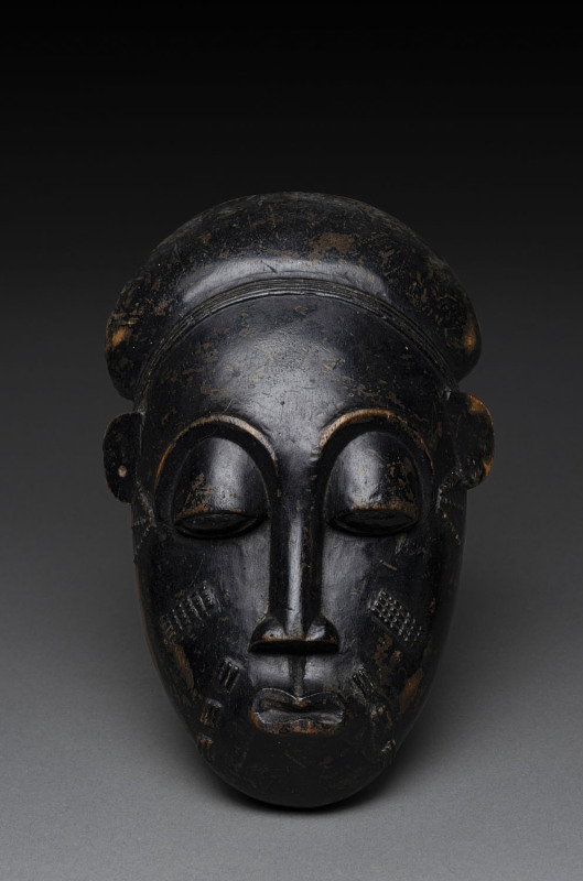 An African face mask, carved wood with patinated finish, Baule tribe, Ivory Coast, ​28cm high