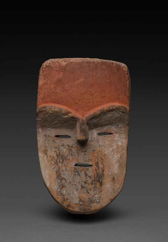 An African mask with orange forehead and slit eyes, carved wood and natural earth pigments, Adouma tribe, Gabon, ​28cm high