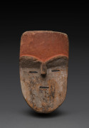 An African mask with orange forehead and slit eyes, carved wood and natural earth pigments, Adouma tribe, Gabon, ​28cm high