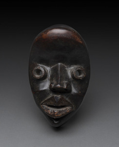 A tribal mask, carved wood with round eyes and dark finish, Dan tribe, Ivory Coast, 25cm high