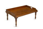 An invalid bed table, mahogany and blackwood, 19th century, ​25cm high, 63.5cm wide, 40cm deep