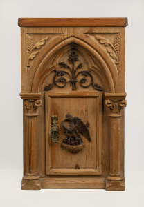 A Continental Gothic cabinet, carved Baltic pine with phoenix door, 19th century, later top, 58cm high, 37cmwide, 32cm deep