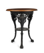 An antique pub table, cast iron base with hardwood top, 76cm high, 56cm diameter