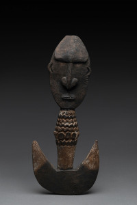 A food hook, carved wood with remains of piped clay, Papua New Guinea, 41cm high