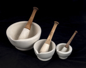 Three antique graduated ceramic mortar and pestles, late 19th century, the largest 21cm diameter