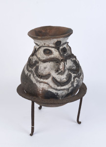A cooking pot, terracotta and piped clay on iron stand, Upper Sepik region, Papua New Guinea, early to mid 20th century, 52cm high, 37cm diameter overall