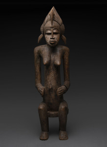 A seated female figure with pelican head dress, carved wood, Senufo tribe, Ivory Coast, 87cm high