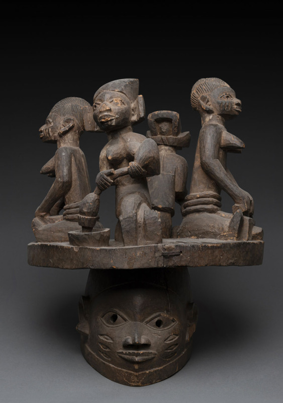 Gelede society mask topped with four figures, carved wood, Yoruba tribe, Nigeria, ​55cm high, 41cm wide