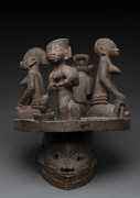 Gelede society mask topped with four figures, carved wood, Yoruba tribe, Nigeria, ​55cm high, 41cm wide