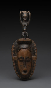A mask with figural top, carved and patinated wood, Baule tribe, ivory Coast, 39cm high