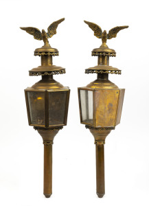 A pair of brass coach lamps with spread-eagle finials, 80cm high