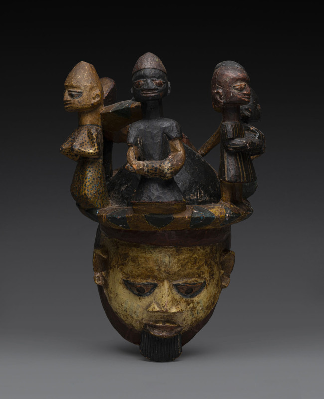 Gelede mask adorned with five figures, carved wood with polychrome finish, Yoruba tribe, Nigeria, 41cm high.