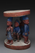 A circular stool with five standing figures, carved and polychrome timber, Yoruba tribe, Nigeria, ​49cm high, 37cm wide