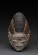 Gelede mask with ornate hair decoration, carved wood with remains white ochre, Yoruba tribe, Nigeria, ​30cm high