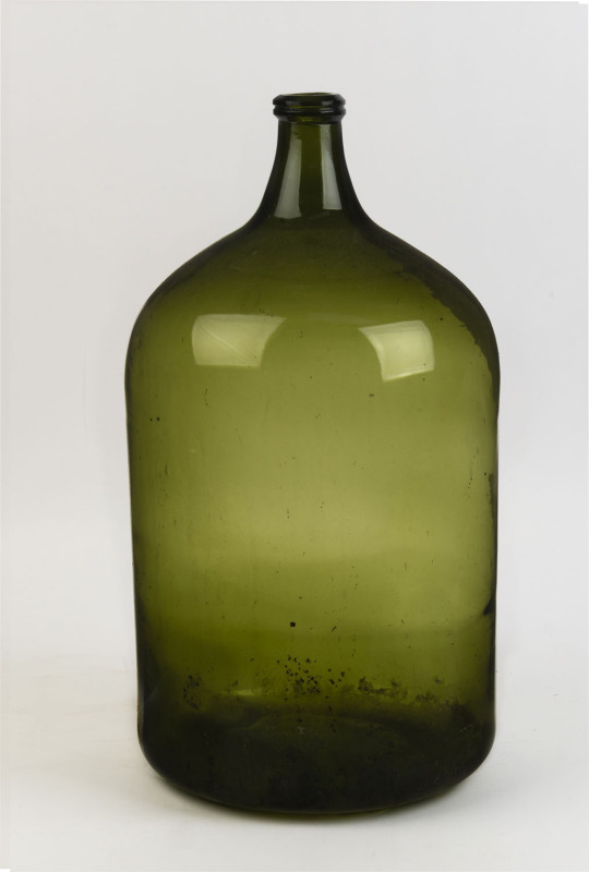 A French green glass wine demijohn, 19th/20th century, ​55cm high, 32cm diameter