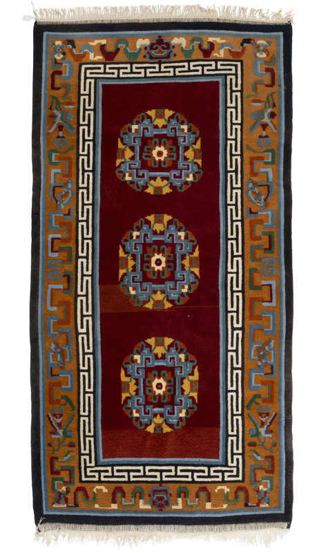 A Chinese wool rug with three medallions, 20th century, 190 x 95cm