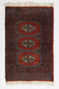 A small Turkoman hand-woven wool rug, 100 x 61cm