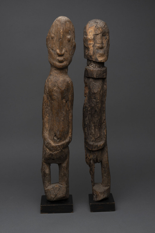 Two standing statues, carved wood, Dogon tribe, Mali, ​later wooden plinths, 57cm and 57cm high