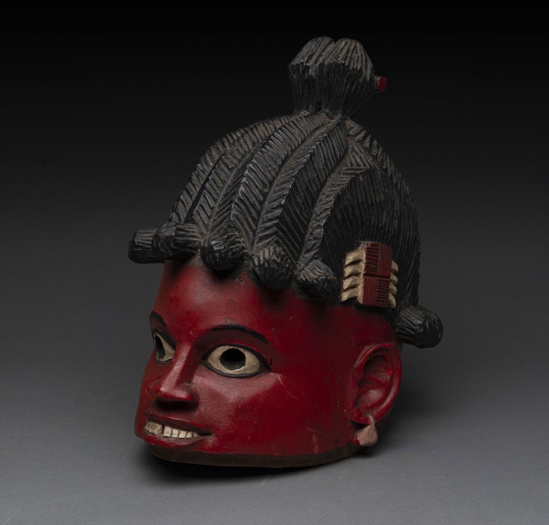 A dance mask, carved wood with red, white and black painted finish, Yoruba tribe, Nigeria, ​35cm high