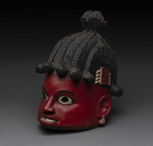 A dance mask, carved wood with red, white and black painted finish, Yoruba tribe, Nigeria, 35cm high