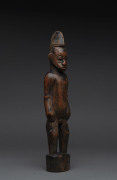 A male standing figure, carved wood with remains of red finish, Senufo tribe, Ivory Coast, ​38cm high