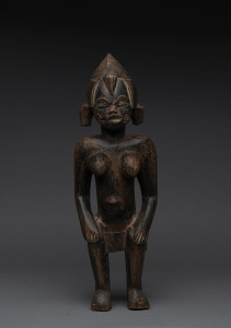 A seated female figure, carved wood with remains of black finish, Senufo tribe, Ivory Coast, 39.5cm high