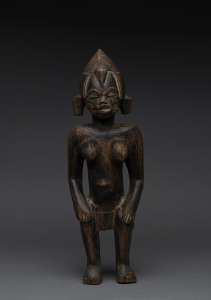 A seated female figure, carved wood with remains of black finish, Senufo tribe, Ivory Coast, ​39.5cm high