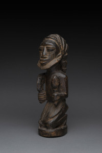 Eshu kneeling figure, carved and patinated wood, Yoruba tribe, Nigeria, 38cm high