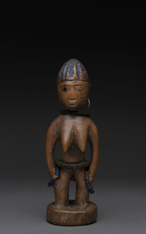 Ibegi female standing nude figure, carved wood, metal earring, trade beads with blue painted hair, Yoruba tribe, Nigeria, ​23cm high