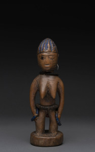 Ibegi female standing nude figure, carved wood, metal earring, trade beads with blue painted hair, Yoruba tribe, Nigeria, 23cm high