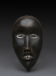 A ceremonial mask, carved and painted wood with metal eyes and teeth, Dan tribe, Ivory coast, 19cm high