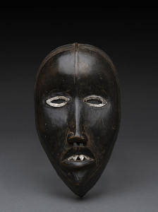 A ceremonial mask, carved and painted wood with metal eyes and teeth, Dan tribe, Ivory coast, ​19cm high