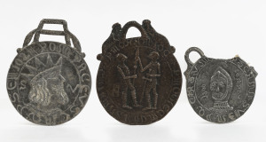 Three English Medieval style pilgrim medallions, two lead, one bronze, 19th century, the largest 11.5cm high