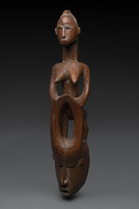 A horned mask with female figure, carved wood, Senufo tribe, Ivory Coast, 65cm high
