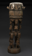 A ceremonial drum with eight standing figures, carved wood and hide, Yoruba tribe, Nigeria, 90cm high