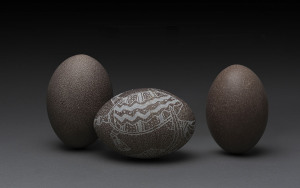 Three assorted emu eggs, one carved (damaged), early 20th century, ​the largest 13cm long