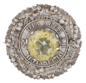 A Scottish style sterling silver and citrine buckle brooch inscribed "DIA AGUS AR DUTHAIGH" (God and country), made in Birmingham, circa 1886, ​7.5cm wide