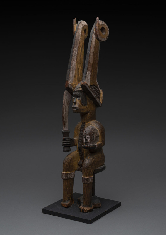 Ikenga figure with horned head dress, carved wood with earth pigments, Ibo tribe, Nigeria, ​on later wooden base, 58cm high