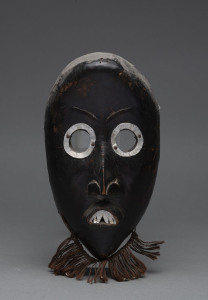 A mask, carved wood with metal teeth and eyes, Dan tribe, Ivory Coast, 23cm high