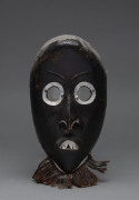 A mask, carved wood with metal teeth and eyes, Dan tribe, Ivory Coast, ​23cm high
