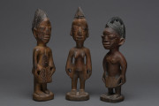 Three Ibegi figures, carved wood with paint and ochre finish, Yoruba tribe, Nigeria, ​30cm, 28cm and 26cm high