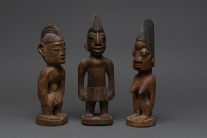 Three Ibegi figures, carved wood with paint and ochre finish, Yoruba tribe, Nigeria, 27cm, 26cm and 24cm high