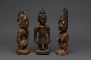 Three Ibegi figures, carved wood with paint and ochre finish, Yoruba tribe, Nigeria, ​27cm, 26cm and 24cm high