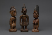 Three Ibegi figures, carved wood with paint and ochre finish, Yoruba tribe, Nigeria, ​27cm, 26cm and 24cm high